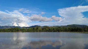 Move over reflection of hill in water at paddy field video