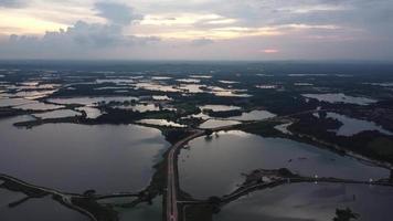 Aerial view asphalt road cross Kampar abandoned tin mining lake video