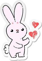 distressed sticker of a cute cartoon rabbit with love hearts vector