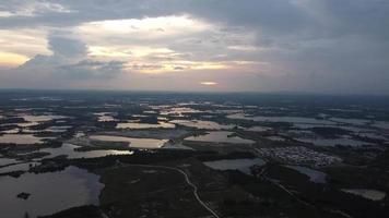 Fly toward abandoned tin mining lake Kampar in sunset hour video