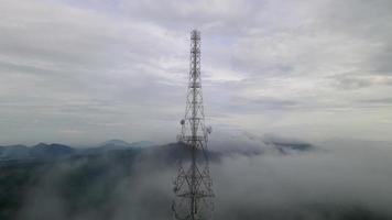 Fast moving misty low cloud cover telecommunication tower video