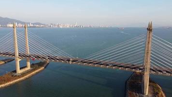 Aerial move away Penang Bridge in blue morning video