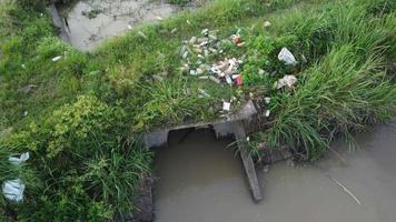 Rubbish thrown beside river bank video