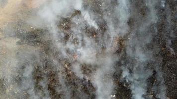 Aerial top down view landfill site caught fire. video