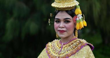 nahaufnahme gesicht der thailändischen frau im traditionellen kleid, das kamera betrachtet. thailändische kultur und thailändisches tanzkonzept. video