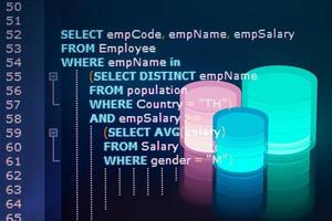 Close-up photo from a computer screen SQL Structured Query Language code and with Database. Example of SQL code to query data from a database.