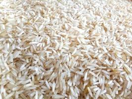 White long rice background, uncooked raw cereals, macro closeup photo