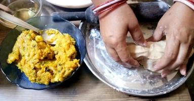 Making of Traditional Indian bread - Aloo paratha or aalu parotha, potato stuffed bread photo