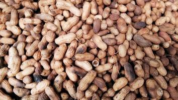 Heap of fresh roasted groundnut in the tray at street shop for sell photo