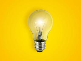 light bulbs on bright yellow background in pastel colors simple concept bright idea ideas isolated lamps photo