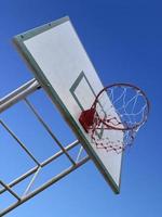 Basketball hoop and blue sky photo