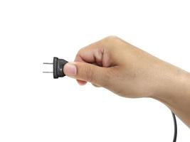 close-up of male hand holding electric plug photo