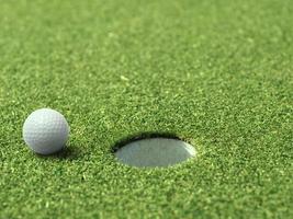 golf ball on lip of cup of lovely beautiful golf course photo