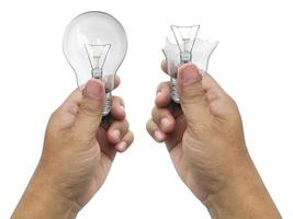 The broken bulb in a hand  Isolated on white background photo