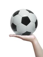 Human hand holding a football isolated on a white background photo