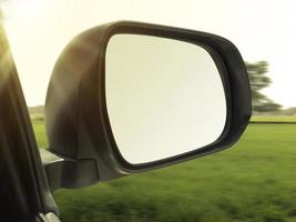 view mirrors in cars at the setting sun, blurred landscape photo