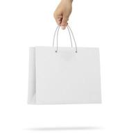 Hand holds a paper bag on a white background photo