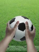 soccer player with ball in his hands on field photo