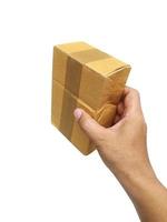hand holding brown paper box package isolated on white background photo