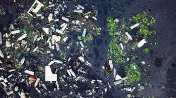 afval verzameld bij donkere rivier. milieu vervuilen. video