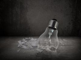 Broken light bulb on old Cement floor photo