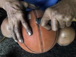 hand pumping up basketball photo