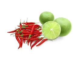 Limes and chilli peppers, isolated on white. A perfect taste combination photo