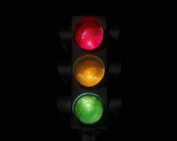 Traffic light on completely dark background photo