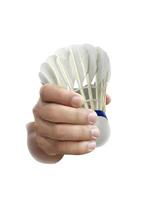 Badminton ball or shuttlecock on hand isolated on a white background photo