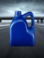 Blue plastic canister of motor oil. on the road highway photo