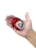 Compressed cans in hand isolated on white background photo