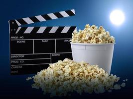 watching movie with popcorn on blue background photo