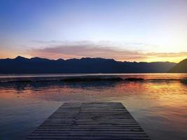 a long pier leading out onto the lake, sunrise on lake, long way out photo