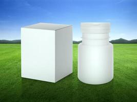 Close up blank medicine bottle and package on green grass field on green fairway with beautiful blue sky photo