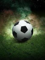 Traditional soccer ball on soccer field. Close up view of soccer ball on green grass with dark toned foggy background. Selective focus photo