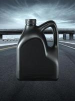 Black plastic canister of motor oil. on the road highway photo