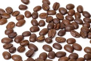 Roasted coffee beans on white photo
