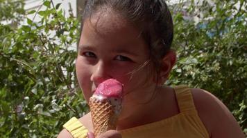 petite fille regardant la caméra en mangeant de la glace video