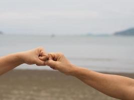 Two woman Alternative handshakes fist clenched hand greeting in the situation of an epidemic covid 19, coronavirus new normal social distancing photo