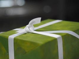 Stacked gift boxes wrapped in green colored paper, Festival Gifts for Christmas and Happy New Year photo