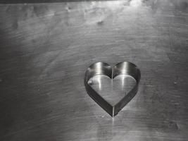 bread molds stainless Heart shaped on aluminum tray background, love Valentine Day for copy text card, background photo