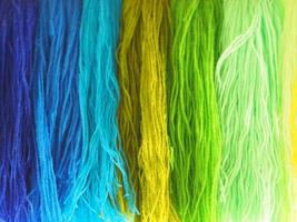 Yarn, Garn several colors arranged abstract Gradient for background, colorful yellow green blue purple violet gold dark and soft color, cool tone photo