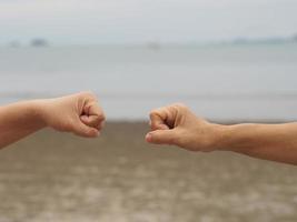 Two woman Alternative handshakes fist clenched hand greeting in the situation of an epidemic covid 19, coronavirus new normal social distancing photo