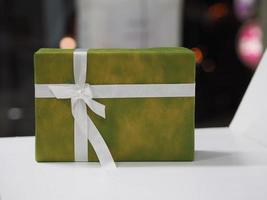 Stacked gift boxes wrapped in green colored paper, Festival Gifts for Christmas and Happy New Year photo