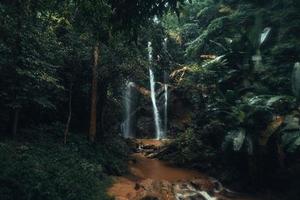 Waterfall in the tropical forest in the rainy season photo