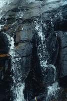 Waterfall in the tropical forest in the rainy season photo