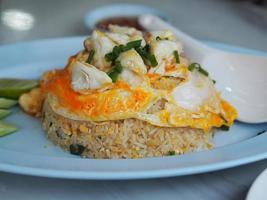 Crab meat fried rice topped with Scrambled egg, style Thai food photo