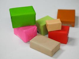 Stacked gift boxes wrapped in multi colored paper, Festival Gifts for Christmas and Happy New Year photo