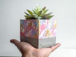 Modern geometric concrete planter. Beautiful painted concrete pot. photo