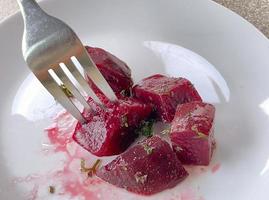 Beetroot veggie with salad on white dish. photo